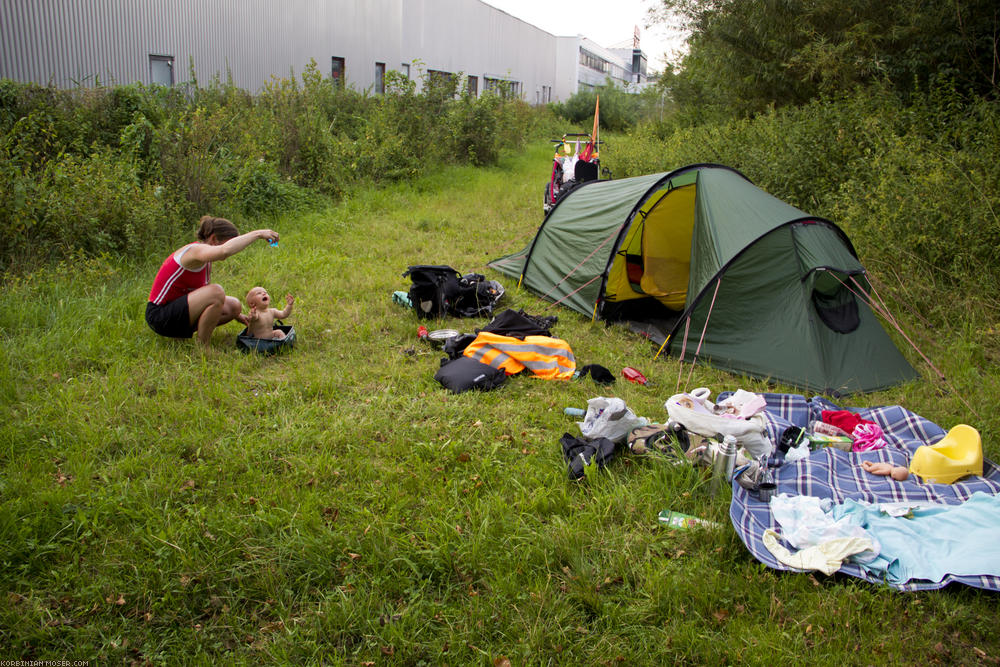 ﻿Industrial area. Since it's time for Mona now, we raise our tent behind a factory.