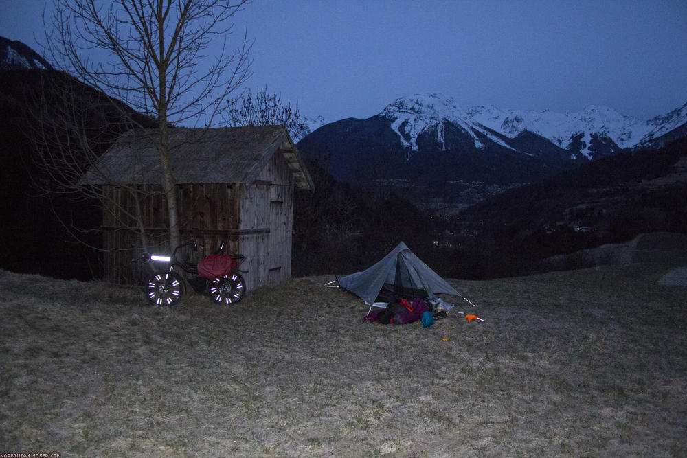 ﻿Close to the edge. The weather forecast is good, it's nearly night, and in front of me is a bit of flat lawn. I decide to camp here. A few meters behind the tent it goes about 100 m vertically down into the Inn canyon. With -8°C the night becomes colder than expected, but I survive it with warm feet. But my drinking water froze by my side. And the tarptent is covered with hoar frost on the inside in the morning, I will have to raise it again later for drying.