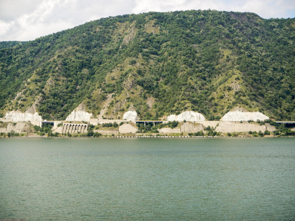 Nibbled on. The road on the Romanian side of the river is carved passages from bridges and in the stone.